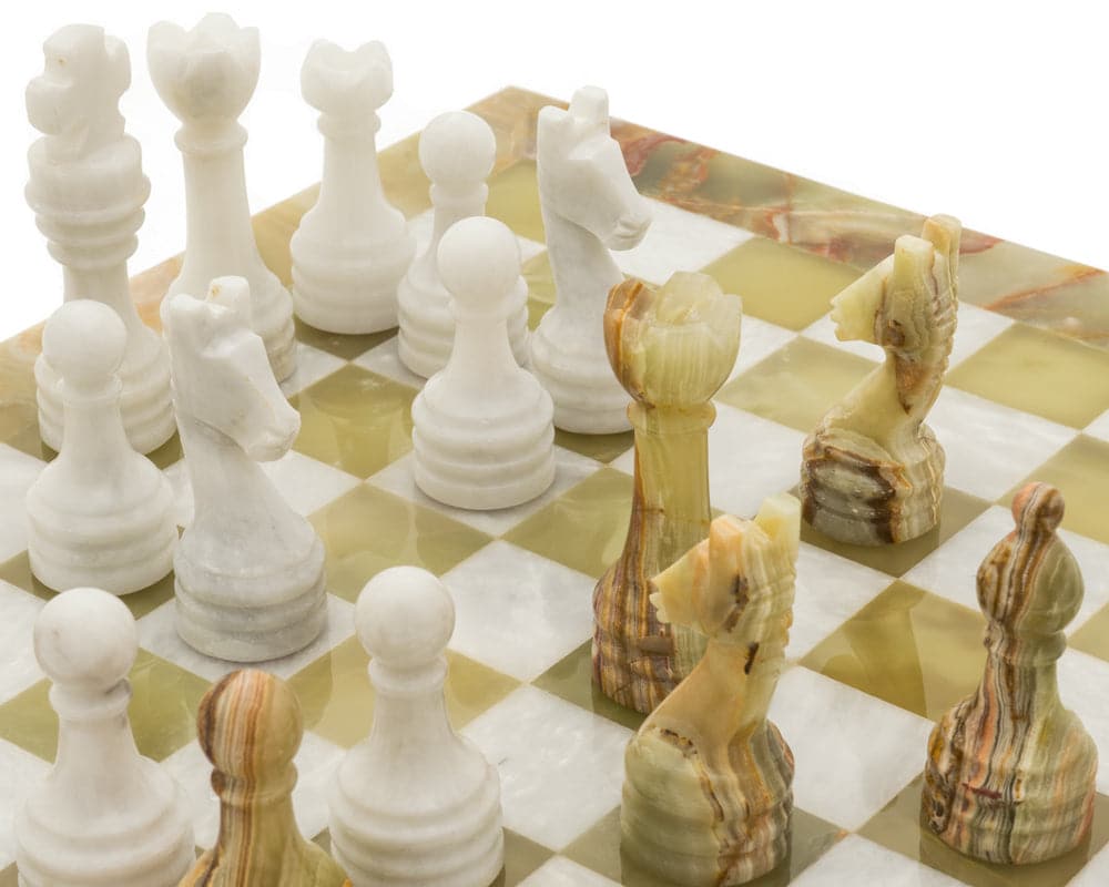 The Alghero Onyx and Marble Chess Set with detailed handcrafted pieces on a polished marble board.