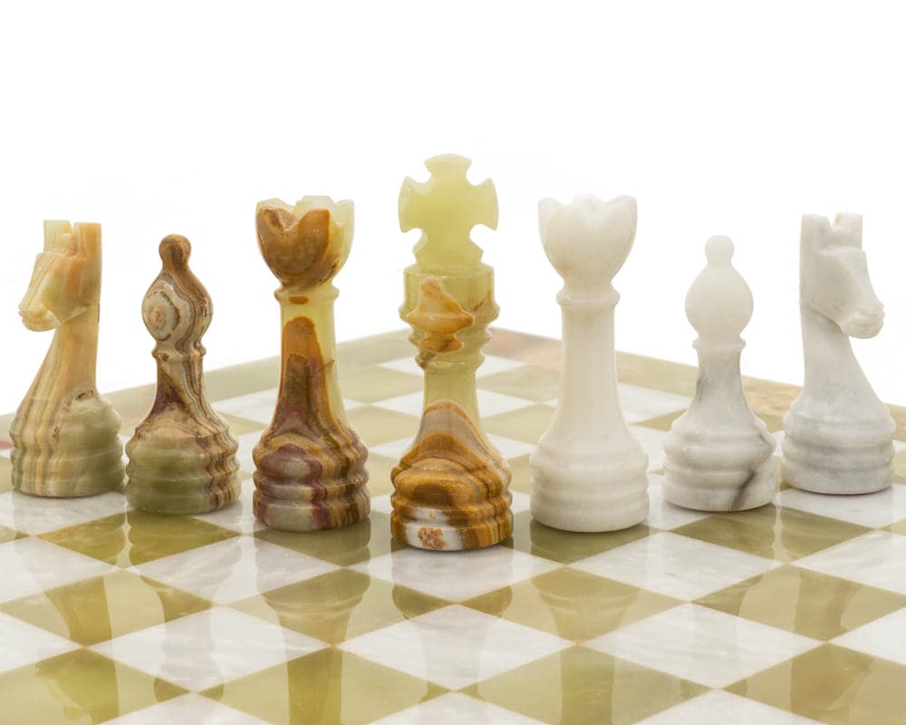 Alghero Onyx and Marble Chess Set on chessboard, showcasing detailed craftsmanship of chess pieces.