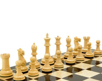 The Victoria Series Ebonised Boxwood Chessmen set up on a chessboard, featuring detailed, weighted, and felted 3.75 inch king pieces.