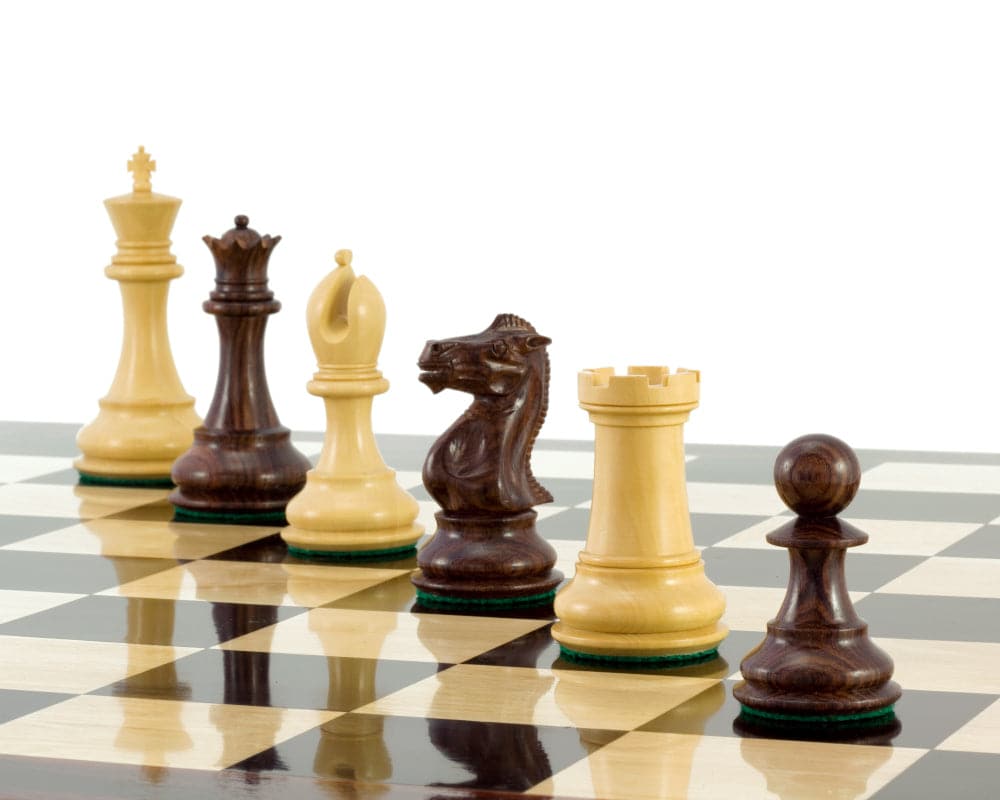 Sandringham Series Rosewood Staunton chess pieces with 4 inch king on a chessboard.