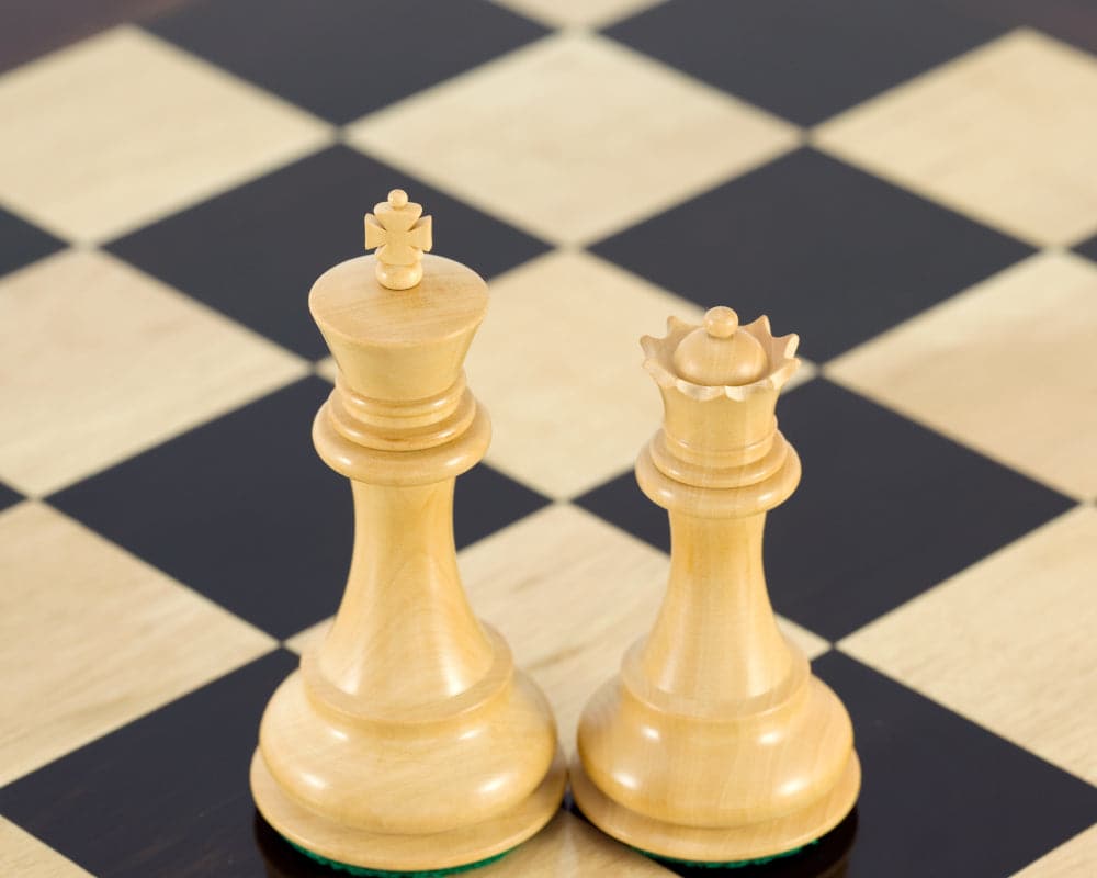 Rosewood Staunton king and queen chess pieces on a checkered chessboard, part of the Sandringham Series.