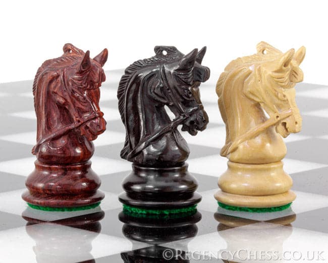 Corinthian Tres Corone 2.5 inch handcrafted chess knight pieces in exotic woods on a chessboard