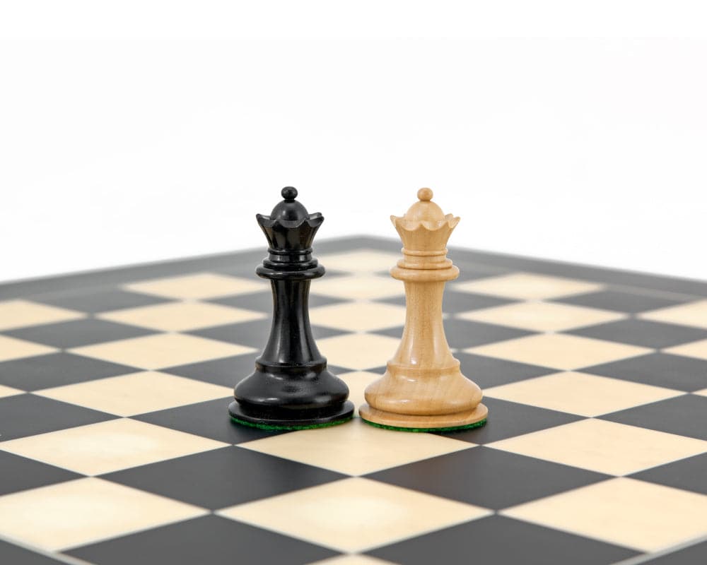 Highgrove Series Ebonised Staunton Chess king pieces on a chessboard