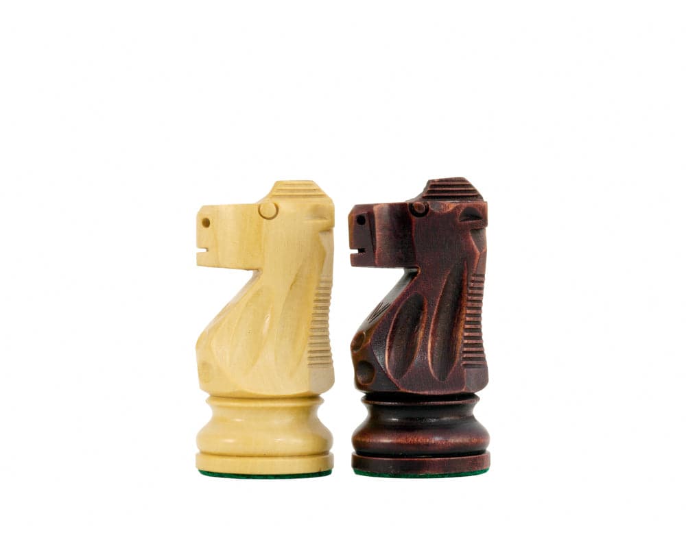 Antiqued Staunton chessmen showing sheesham and boxwood knights with unique stain and polish finish on white background.