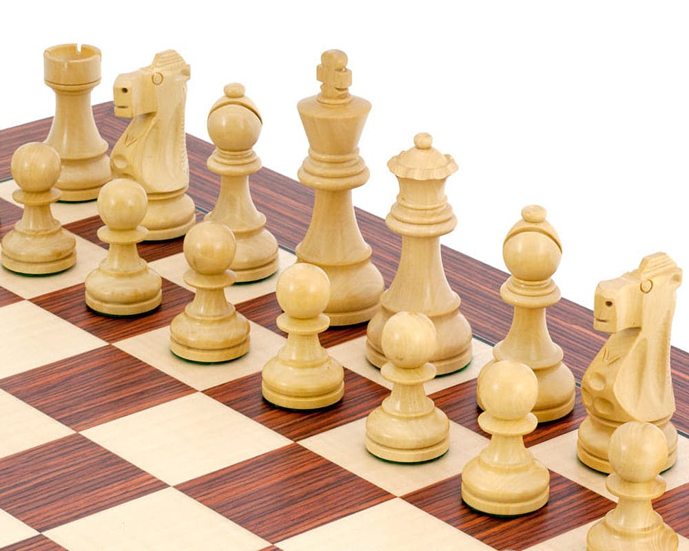 Antiqued British Staunton Chessmen in Sheesham and Boxwood positioned on a chessboard, featuring a 3.75-inch king, presented by Regency Chess Company.