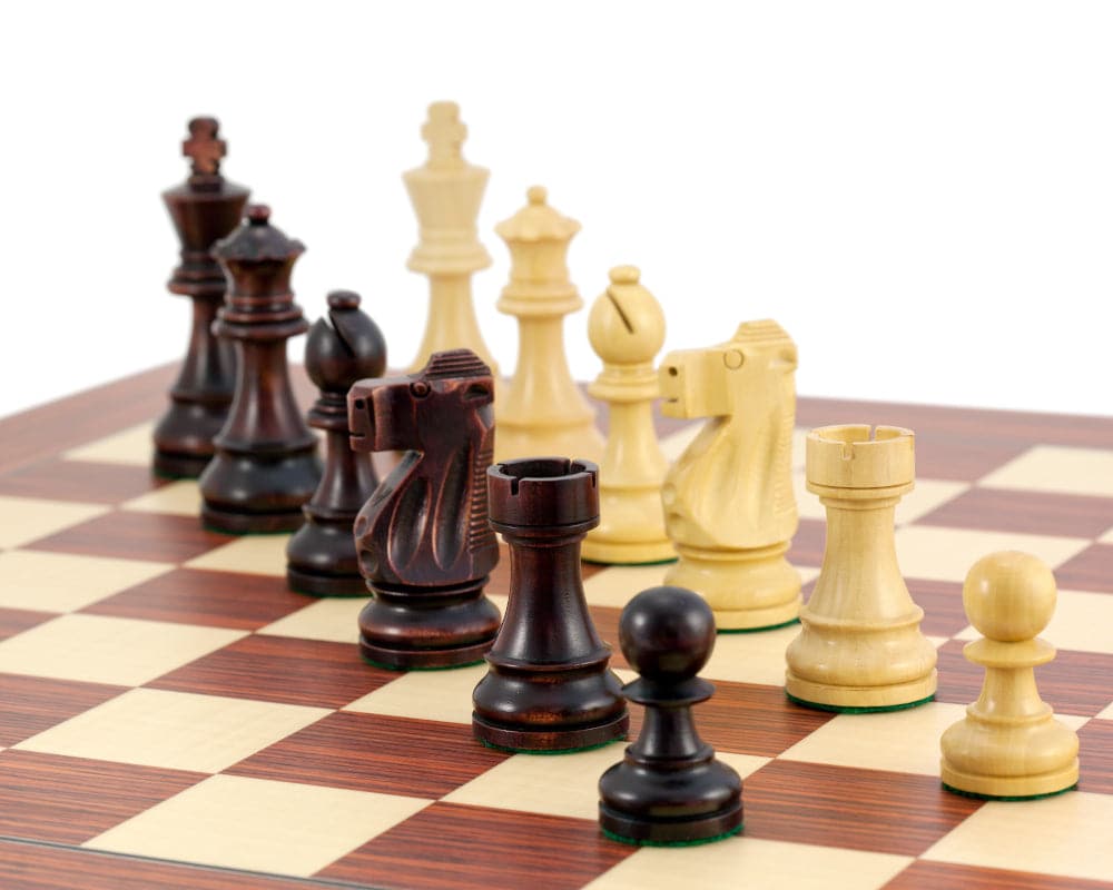 Antiqued British Staunton Chessmen in sheesham and boxwood on chessboard with unique stain and polish finish, 3.75-inch king.