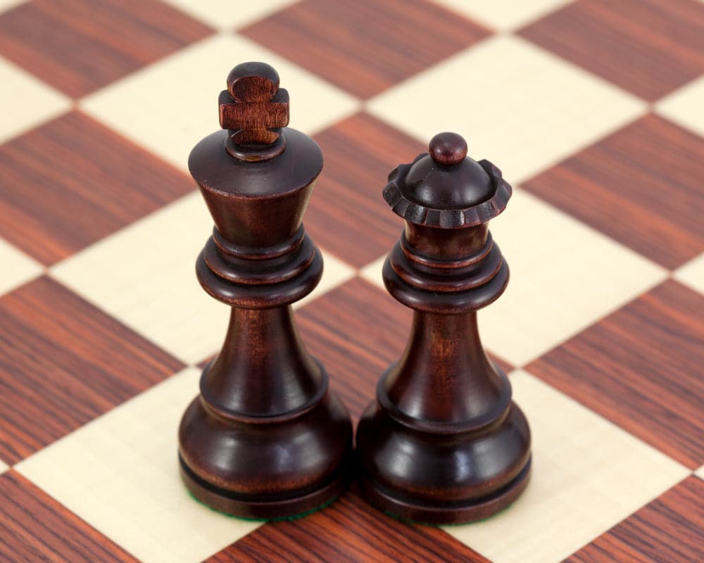 Antiqued British Staunton Chessmen set in sheesham and boxwood with unique stain and polish finish, featuring 3.75-inch king on chessboard