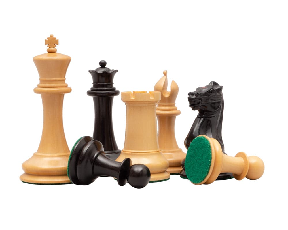 Classic Staunton ebony and rosewood chess pieces on display with green felt bases, featuring king, bishop, rook, knight, and pawns.