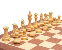 Traditional Staunton design British Ebonised chess men, crafted from boxwood, arranged on a chessboard with a 3.5 inch king and additional queens.