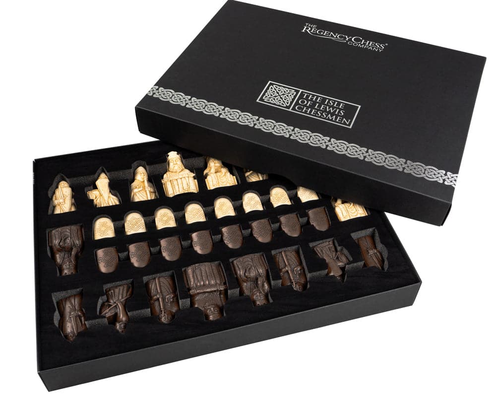 The Isle of Lewis walnut and maple chess set with detailed pieces in an open box