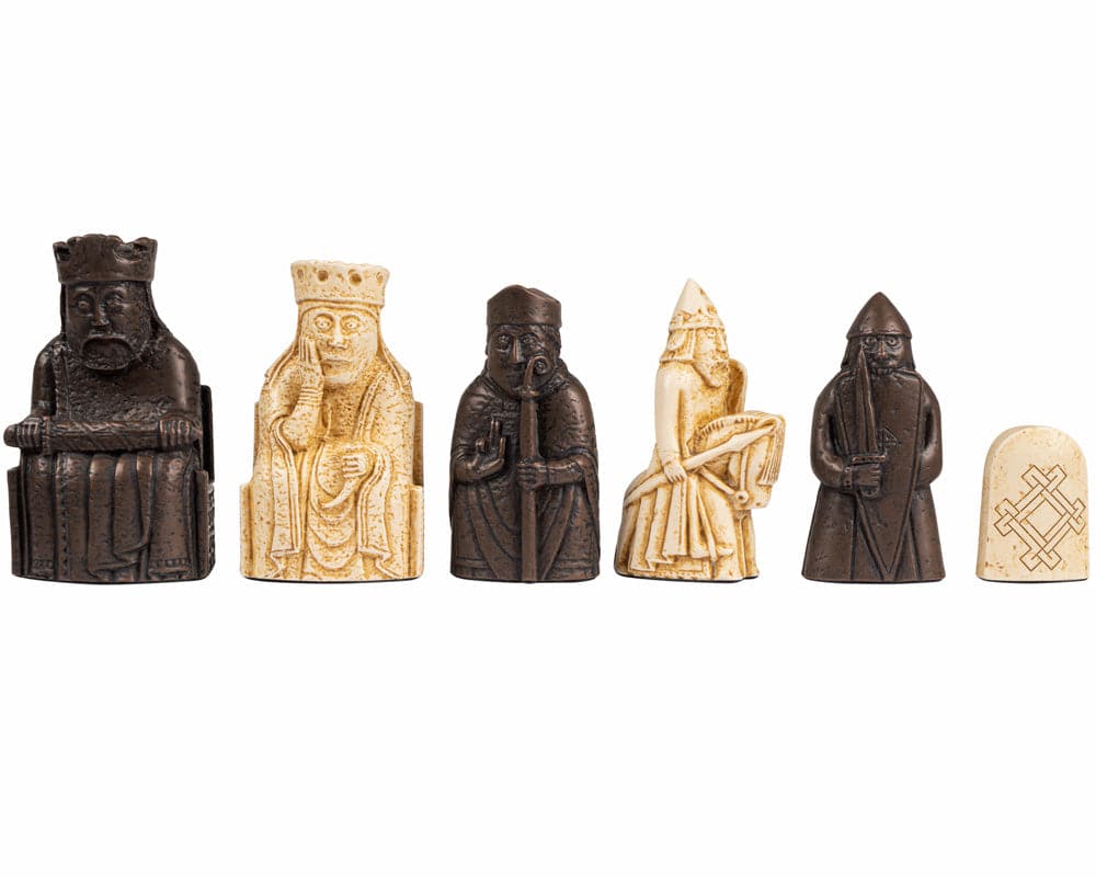 Isle of Lewis chessmen pieces on white background, featuring detailed historical replica chess figures in black and white.