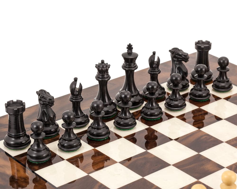 Highclere Ebony and Walnut Luxury Chess Set with 3 inch weighted king, displayed on a beautifully crafted Mahogany and Birch board from Greece