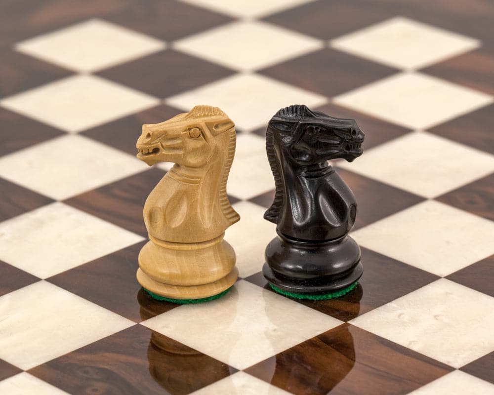 Highclere Ebony and Walnut Luxury Chess Set featuring handcrafted black and natural boxwood knight pieces on a high-quality board.