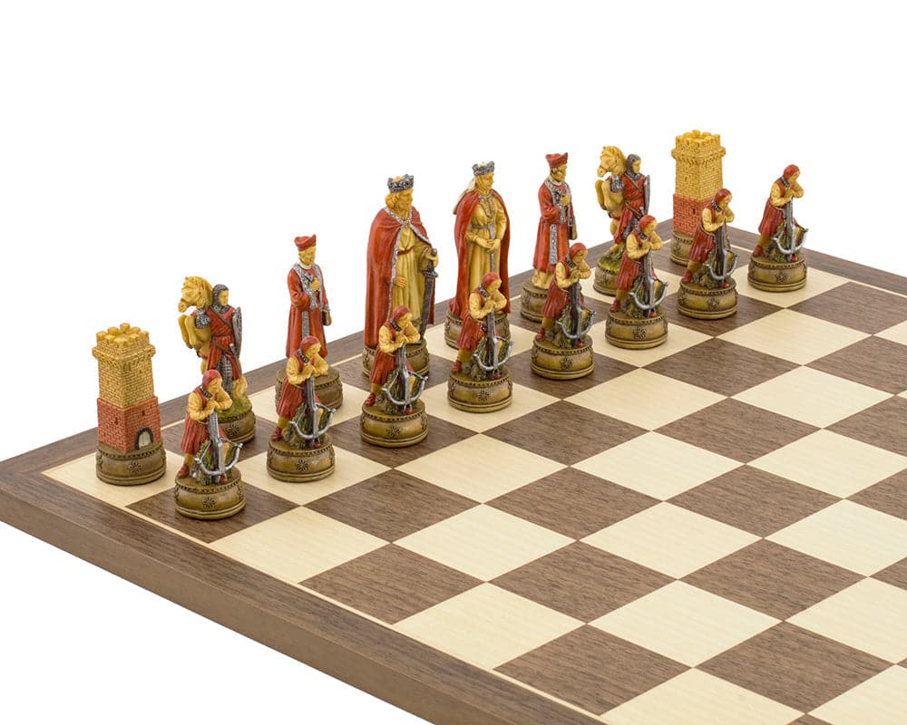 The Camelot Hand Painted themed Chess set by Italfama featuring detailed red and gold chess pieces on a wooden chessboard.