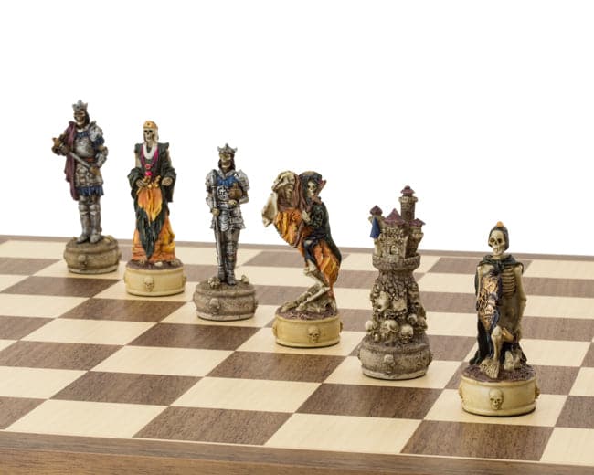 The Zombie Hand Painted Chess Set pieces on a 16 inch board, featuring ornate and gruesome kings, queens, and cloaked bishops, crafted in Italy.