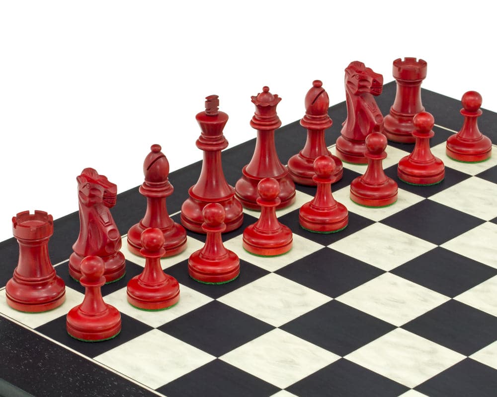 Red and black Staunton chess set with 3.75 inch king, billiard cloth bases, on black and maple board by The Regency Chess Company