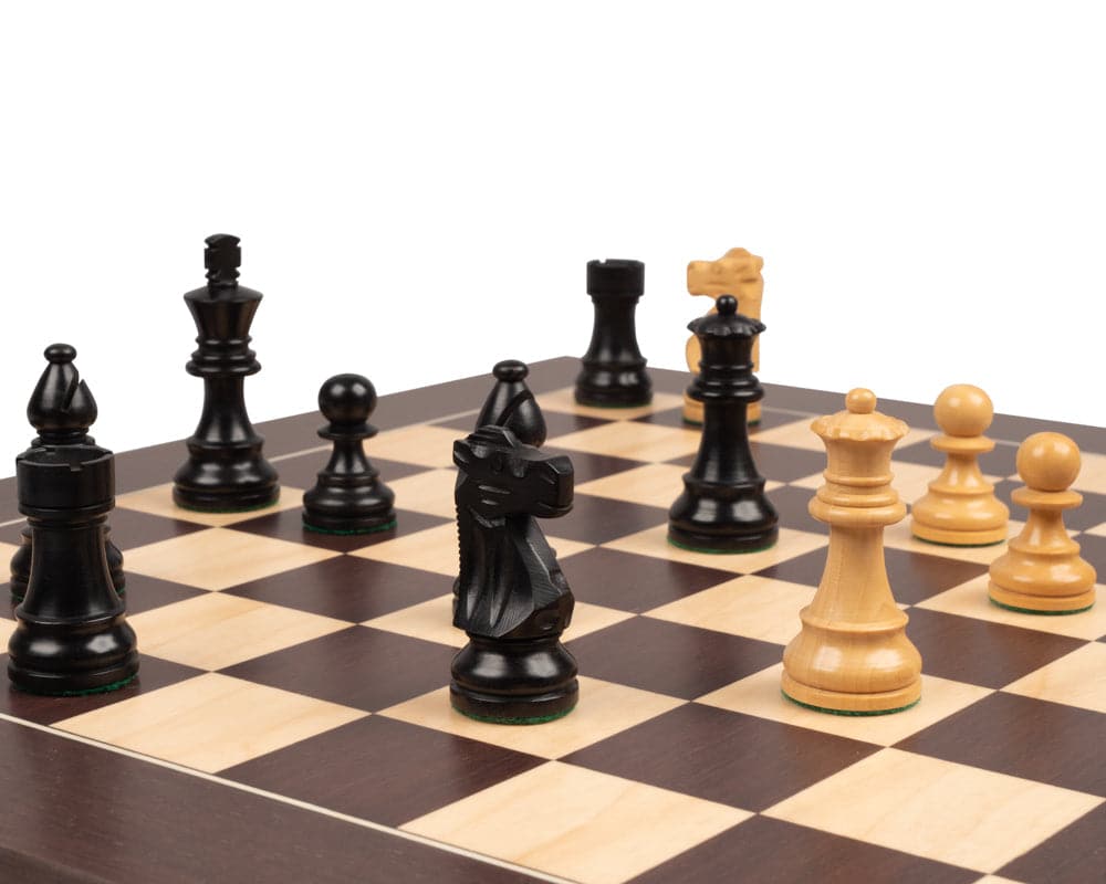 The French Knight Black and Wenge Chess Set with large, quality acacia pieces, including a 4 inch king and two additional queens on a board.