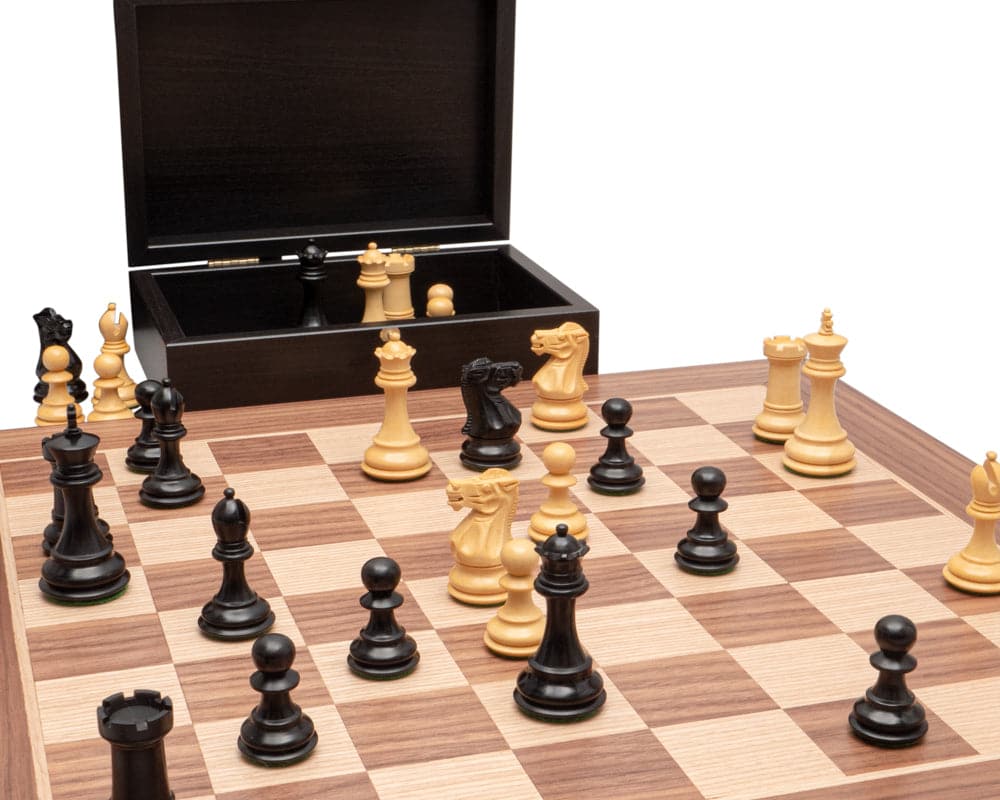 The Highclere Ebony and Walnut Traditional Chess Set with finely crafted ebony chess pieces on a walnut and maple board.