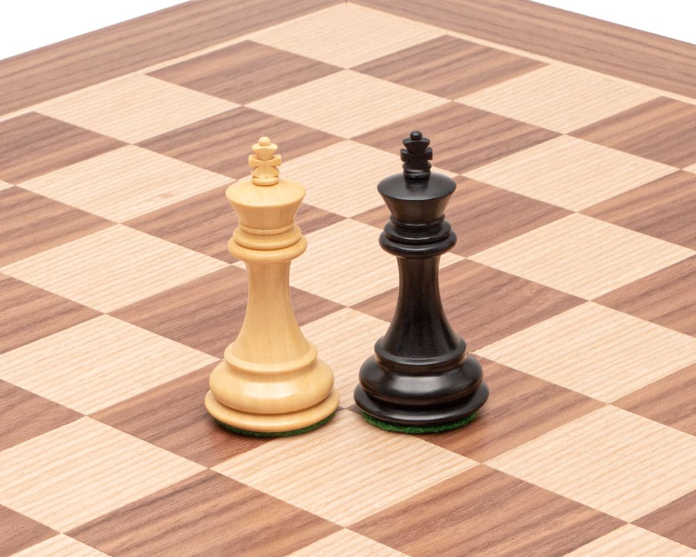 The Highclere Ebony and Walnut Traditional Chess Set with detailed ebony and maple king pieces on a 20 inch walnut board with 2 inch squares