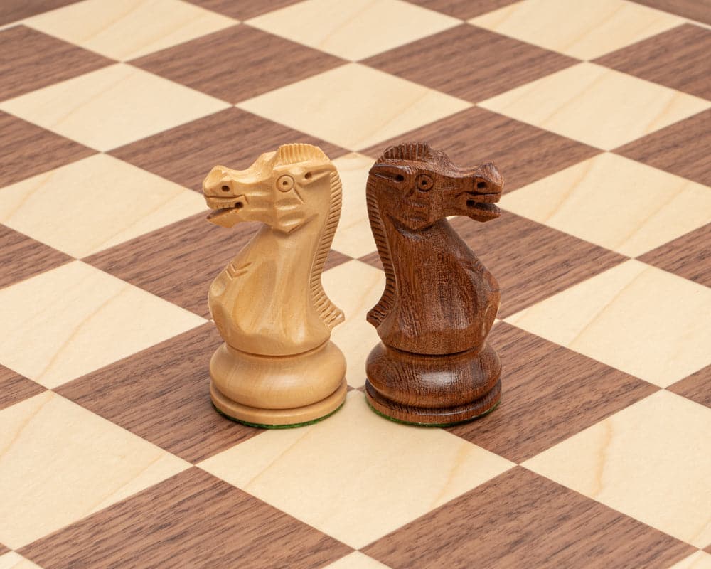 Hand carved sheesham and boxwood knight chess pieces on a walnut and maple chessboard from the Executive Staunton Chess Set.